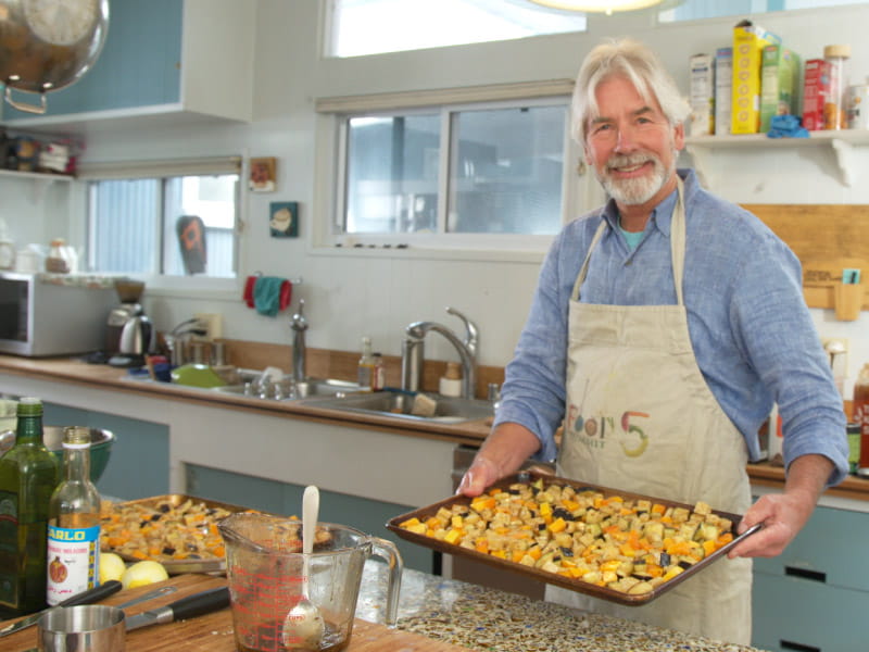 Christopher Gardner in his kitchen preparing to roast butternut squash, eggplant and tempeh. (Photo courtesy of OPS Productions)