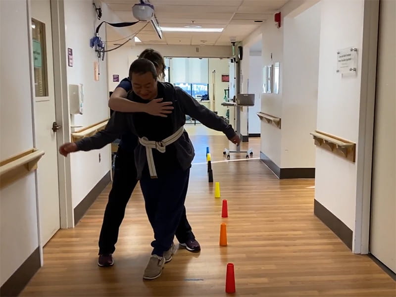 Stroke survivor Yutao Huang at physical therapy