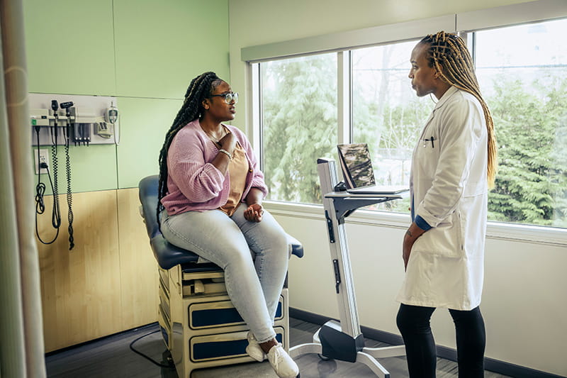 A patient talking to her doctor in a healthcare office