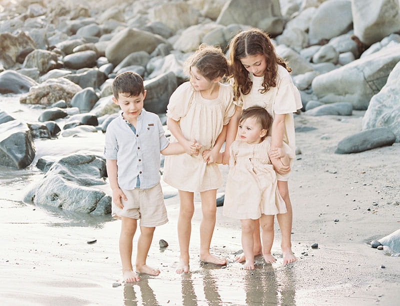 Harry, Abigail, Lily and Molly Carlton play on a California beach in 2022