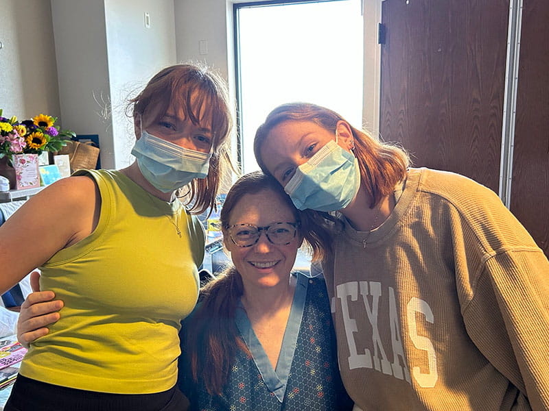 Angie Lowe in her hospital room with daughters Emma Kate (left) and Lillian (right)