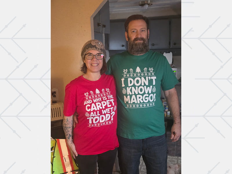 Rikki and Todd Crider in matching holiday shirts in 2025
