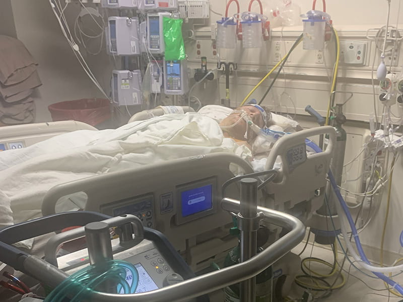 Kyle Hartley connected to a life-support machine in the hospital