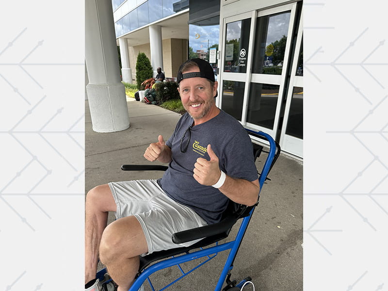 Kyle Hartley leaving the hospital in a wheelchair after his second cardiac arrest