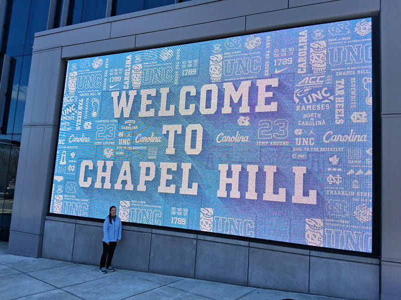 Dr. Kelly R. Evenson outside the Dean E. Smith Center in Chapel Hill