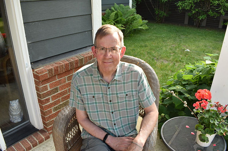 Brent Calhoun sitting outside on a patio in 2025