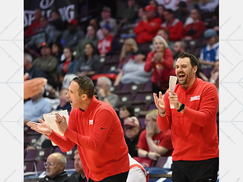 Incarnate Word head coach Dan Rolfes and one of his assistants, Brent Humiston, on the sidelines during a Red Knights girls' basketball game