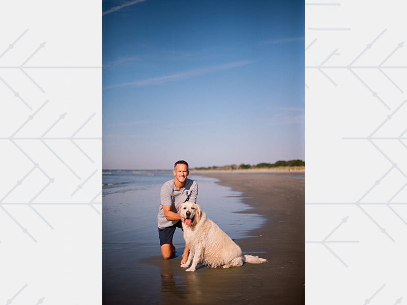 Dan with Hank the dog during a family beach trip