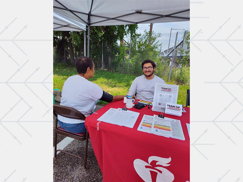 A volunteer conducts a blood pressure measurement for Team Up to Take Down Blood Pressure in Philadelphia