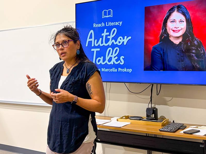 Marcella Prokop speaking at a literacy event in a classroom