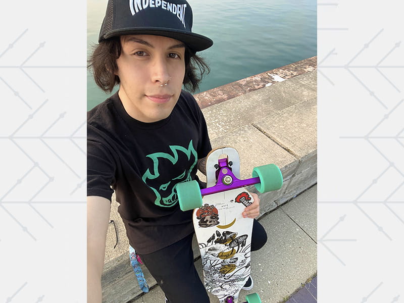 Brian with his longboard in 2023.