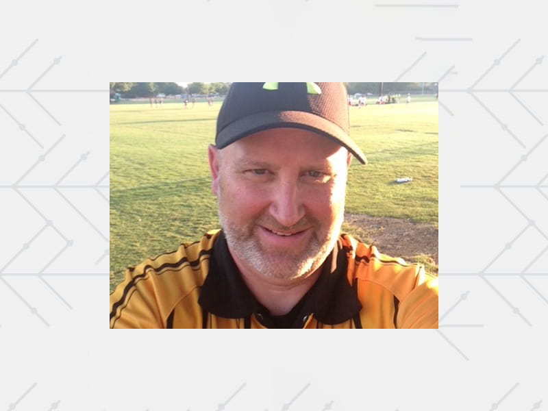 selfie of Brian Sureck in his referee uniform on a soccer field