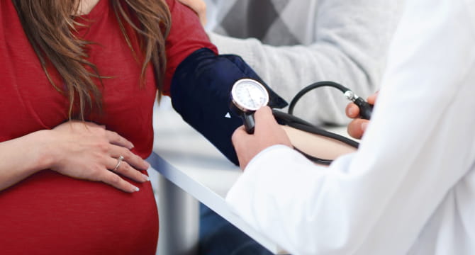 pregnant woman getting blood pressure checked