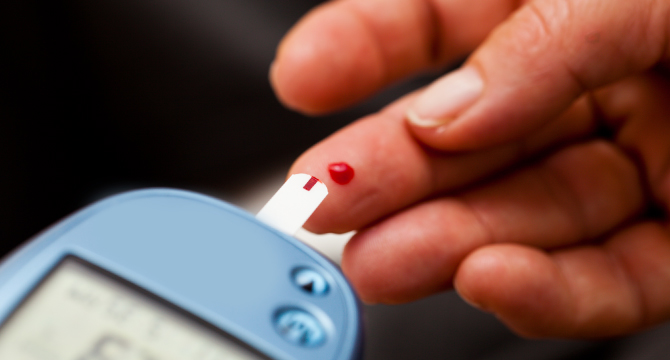 person testing blood for diabetes