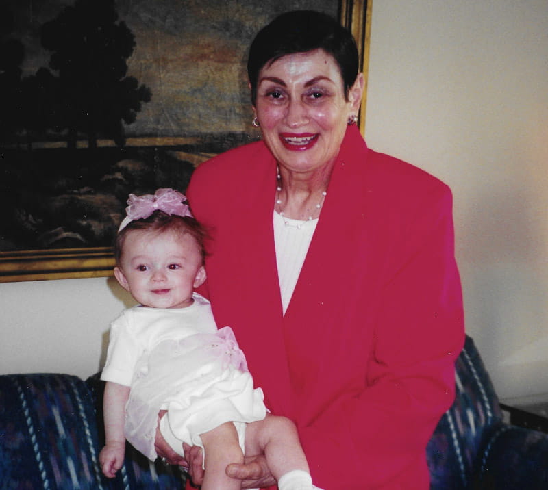Zoe Corrigan as a young child being held by her Yiayia. (Photo courtesy of the Corrigan family)