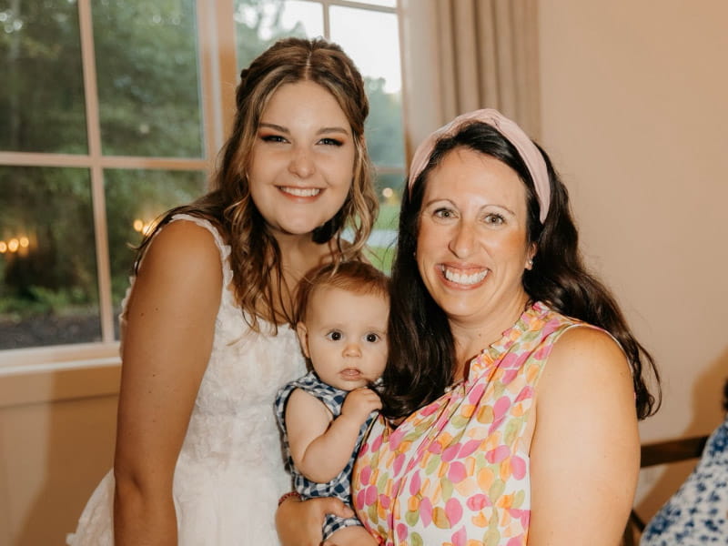 Lorraine Stewart (right) was holding her 4-hour-old son, Court (center), when he stopped breathing. Hallie Allison (left) helped save his life with infant CPR. (Photo courtesy of Lindy Picciotti Photography)