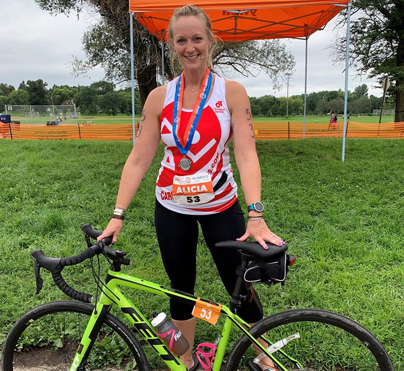 Alicia at the finish line of a triathlon in 2019. (Photo courtesy of Alicia Bravo)