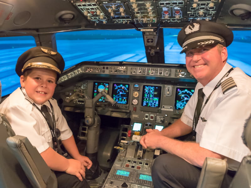 Easton Fryer joins Ric Wilson, VP of flight operations for Envoy Airlines, in the cockpit. (Photo courtesy of Envoy Airlines)
