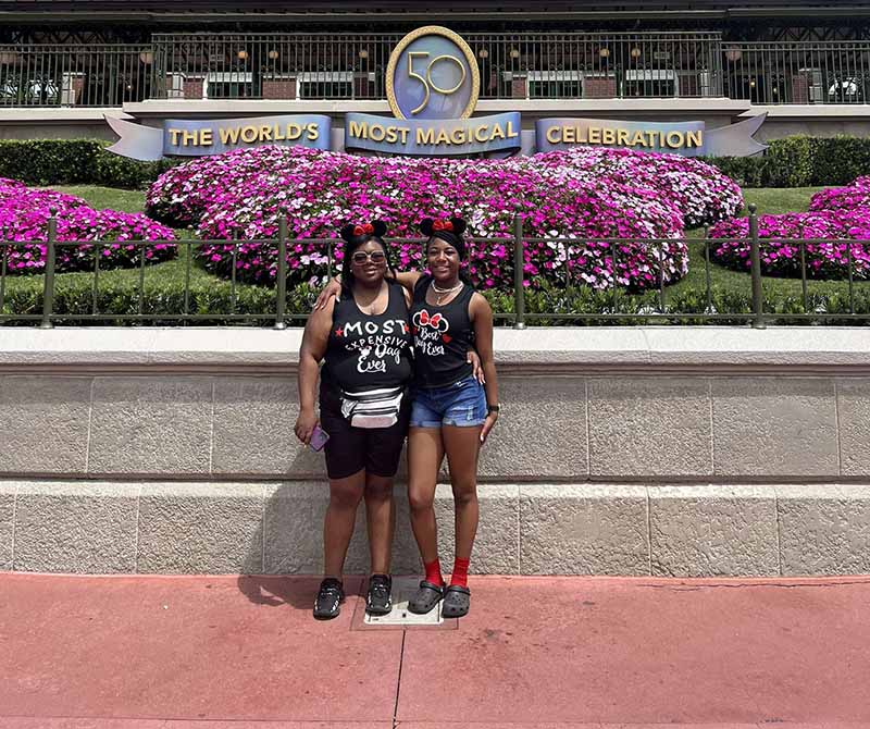 Fatima Mathews (left) with her daughter, Londyn, on their Disneyland trip. Fatima tucks her LVAD equipment into a fanny pack and works the ensemble into her outfits. (Photo courtesy of Fatima Mathews)