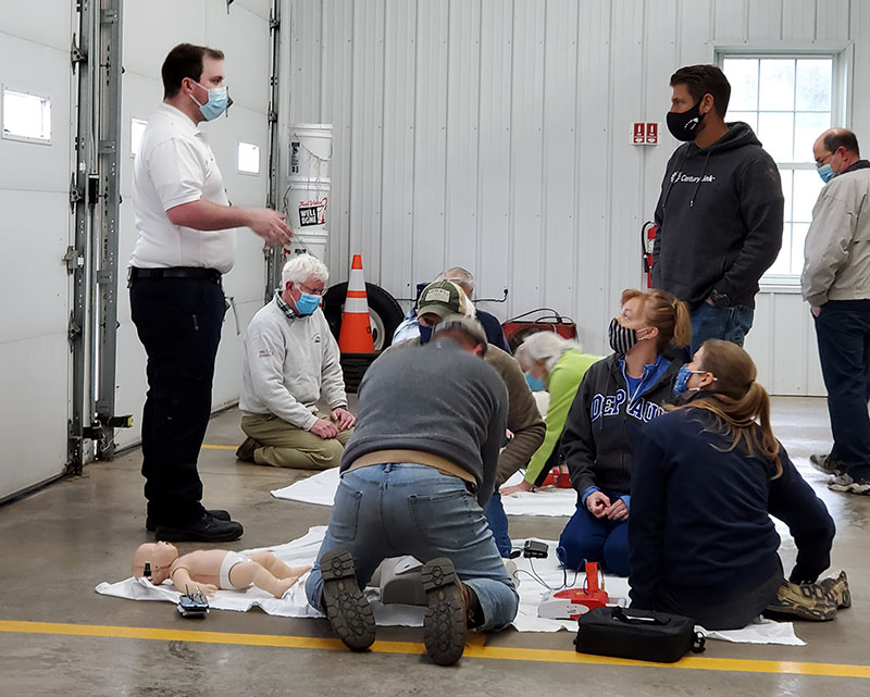 Brian Lockwood - one of the EMTs who responded to Lisa's 911 call - trains a group on CPR. (Photo courtesy of Lisa Wiles)
