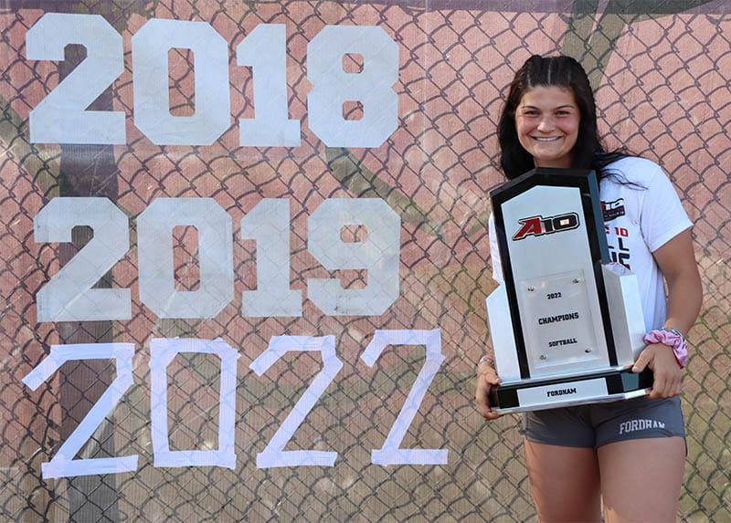 Fordham University softball shortstop Sarah Taffet with the championship trophy her team won this year. (Photo by Makenzie McGrath)