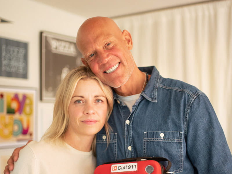 Former Grand Slam champion Murphy Jensen is an expert in overcoming. A year ago this week, he went into cardiac arrest and didn’t breathe on his own for 18 minutes, his latest death-defying episode. He's pictured with his wife, Kate, and their home AED they keep at their house. (American Heart Association)