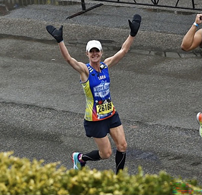 Lora Miele crossing the finish line at the Boston Marathon. (Photo courtesy of Elizabeth Hindinger)