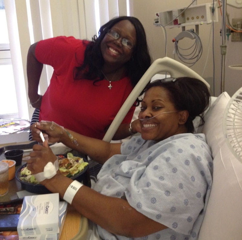 Denise Castille (right) recovering in the hospital with best friend Terri Alexander Mathews by her side. (Photo courtesy of Denise Castille)