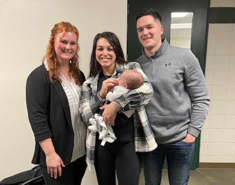 Rhaeann Shepler, a school nurse, performed CPR and used an AED to restart Alexis Simon's heart. From left: Rhaeann, Alexis holding son Dominic, and husband Dan.(Photo courtesy of the Simon family)