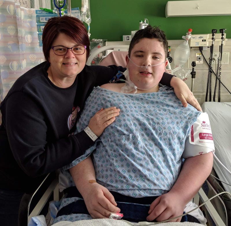 Ethan Rutherford (right) recovering in the hospital with his mom, Erin, by his side. (Photo courtesy of the Rutherford family)