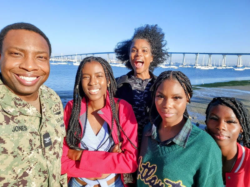 Sybil Jones (back center) and Marcus (far left) in San Diego with their three daughters. (Photo courtesy of Sybil Jones)