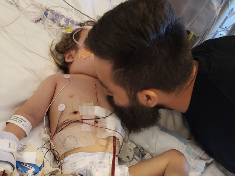 Dad Carlos kisses Ruben after his heart transplant.