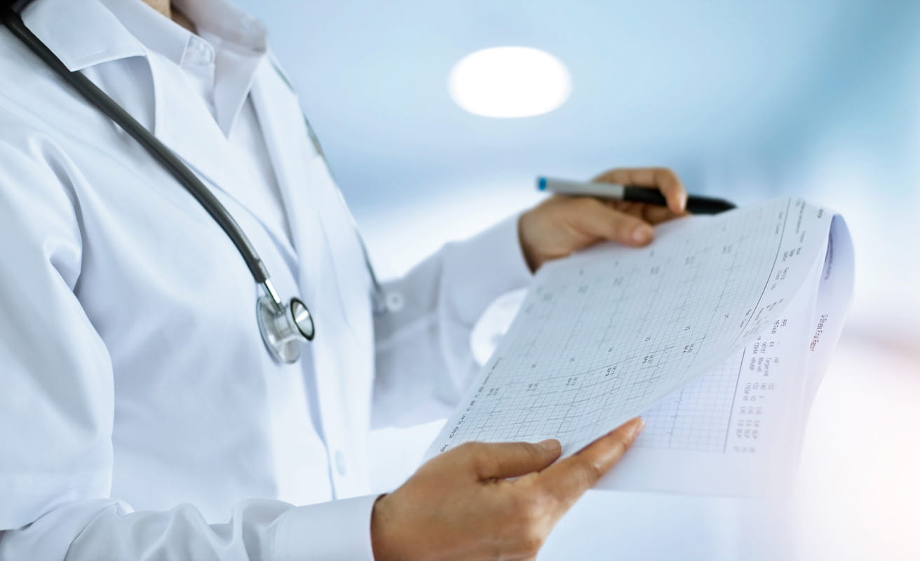 Image of physician examining a paper document 