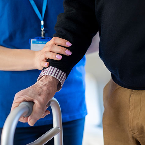 SNF Nurse with Man Using Walker