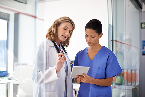 female doctor consulting with female nurse