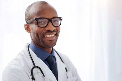 stock photo of male doctor smiling at camera