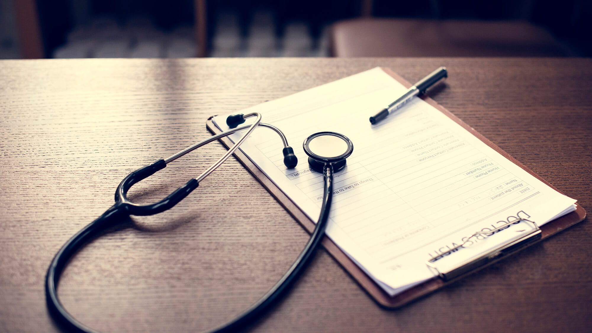 checkup form and stethoscope on desk