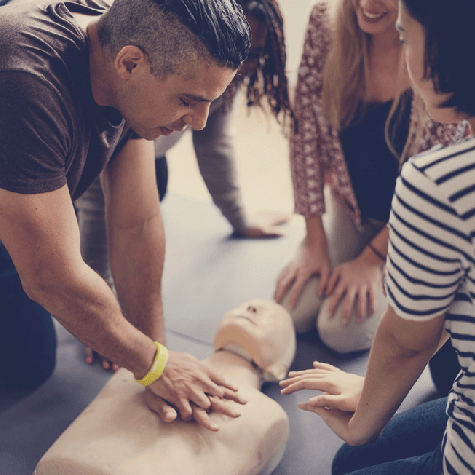 man performing CPR on CPR manikin
