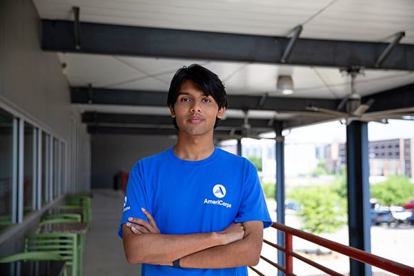 Young man AmeriCorps volunteer posing at facility