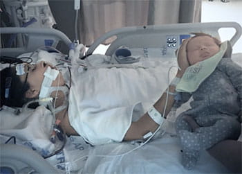 Jen Rohe, heart disease survivor in hospital bed postpartum Jen Rohe, heart disease survivor in hospital bed postpartum
