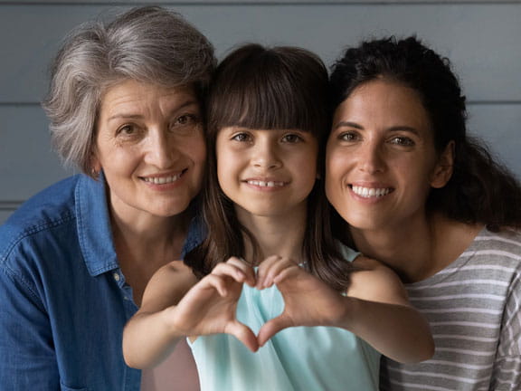 family of women close up making heart hands