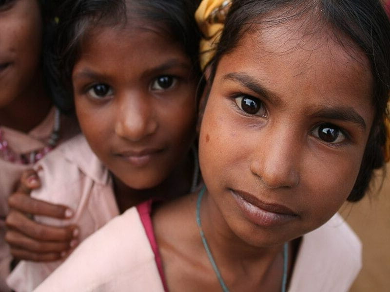 closeup photo of young Indian girls looking at camera