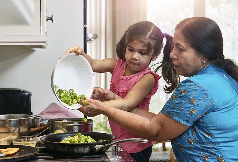 Grandmother and granddaughter cooking