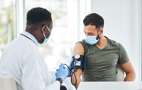 man getting his blood pressure taken