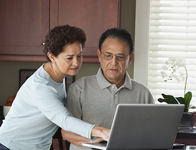 Couple looking at a laptop