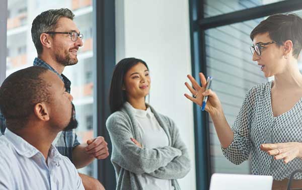 Diverse employees discussing business in office setting