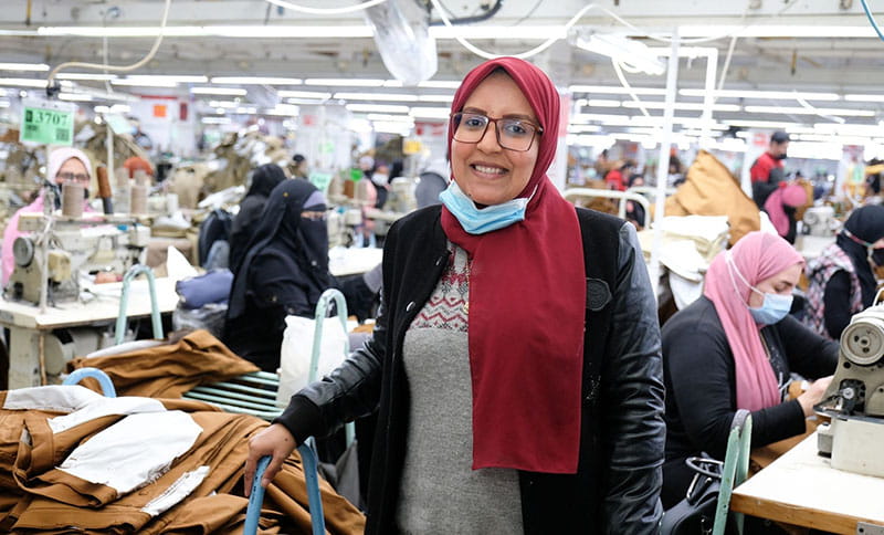 Smiling employee at Levi Strauss production facility