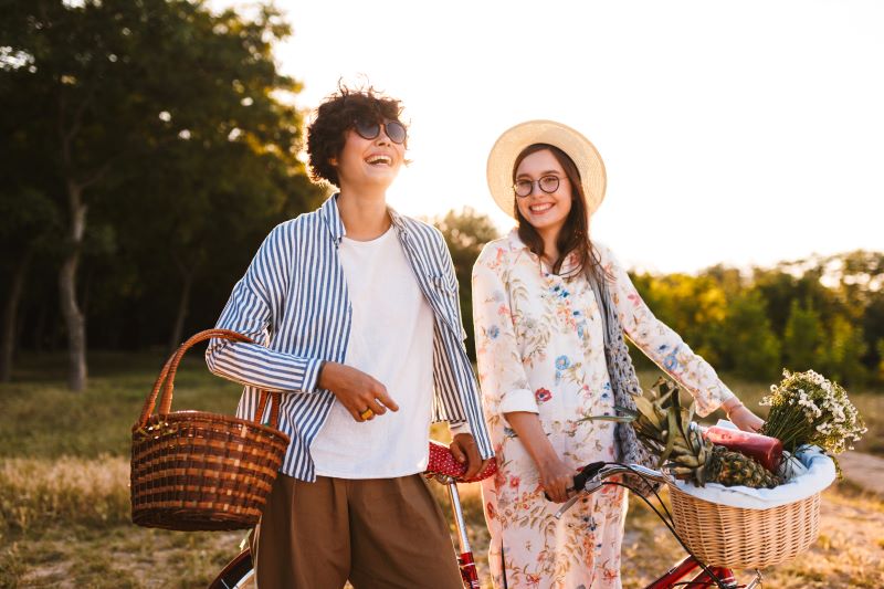 Two smiling women getting ready for a bike ride