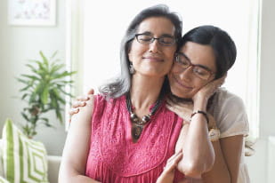 Mother and daughter standing together