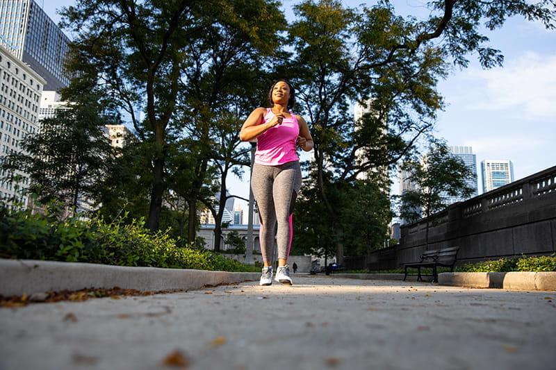 Couple walking or running outdoors in sunlight